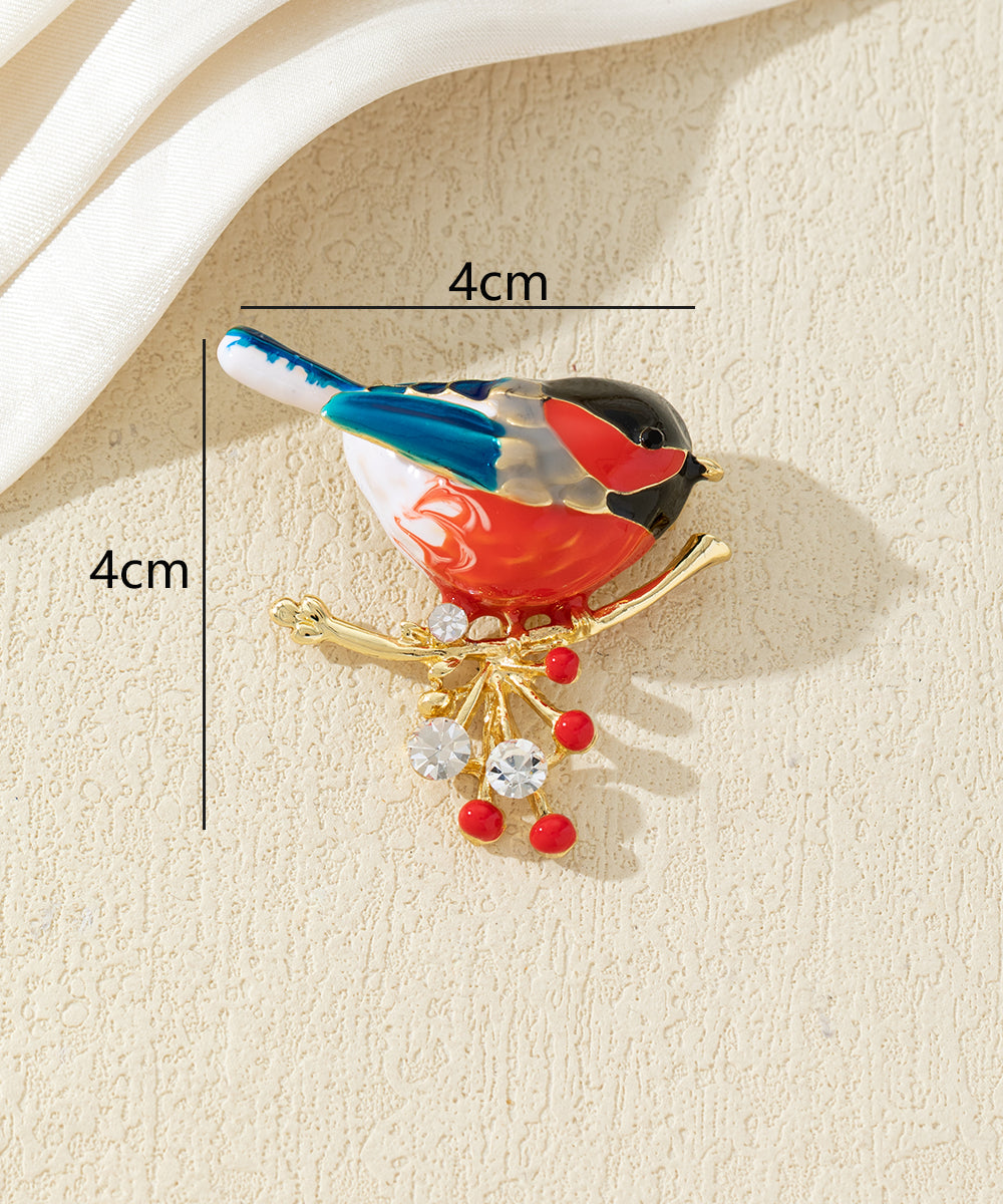 Broche oiseau coloré sur branche