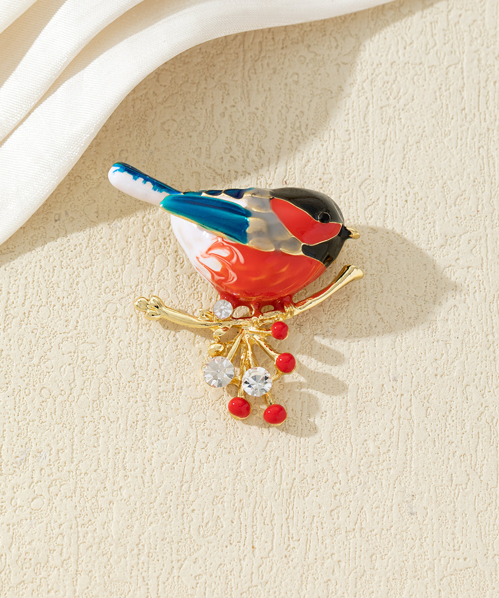 Broche oiseau coloré sur branche