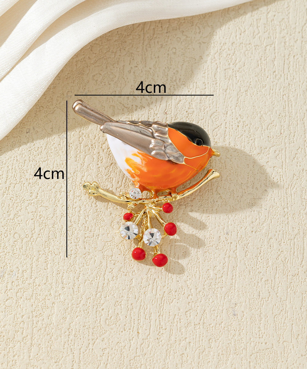 Broche oiseau coloré sur branche