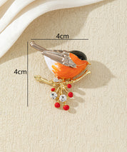 Broche oiseau coloré sur branche