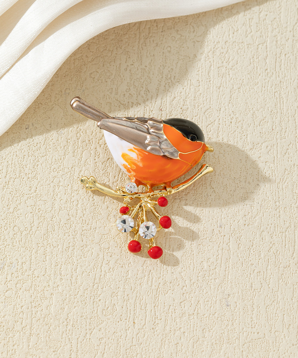 Broche oiseau coloré sur branche