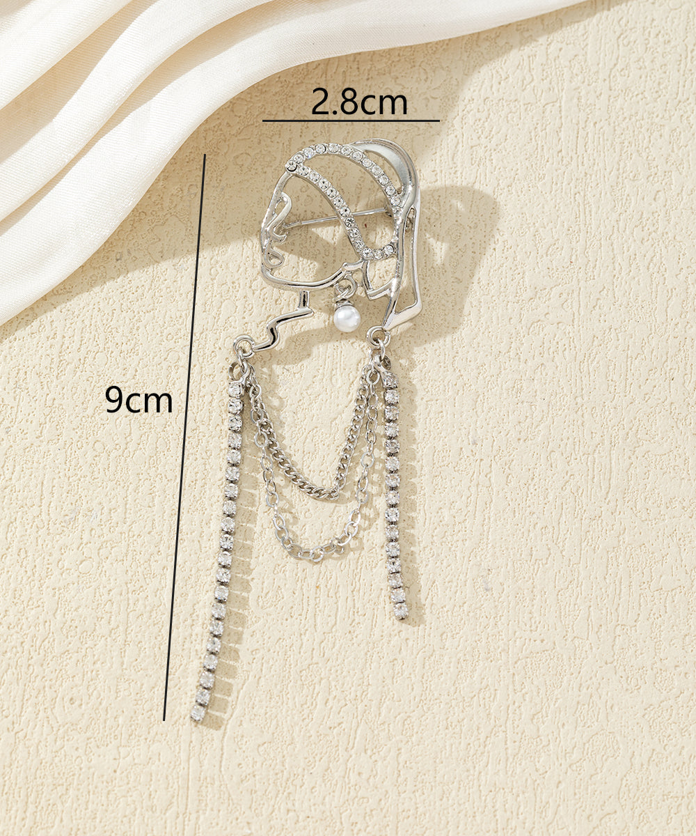 Broche visage féminin avec chaînes strass