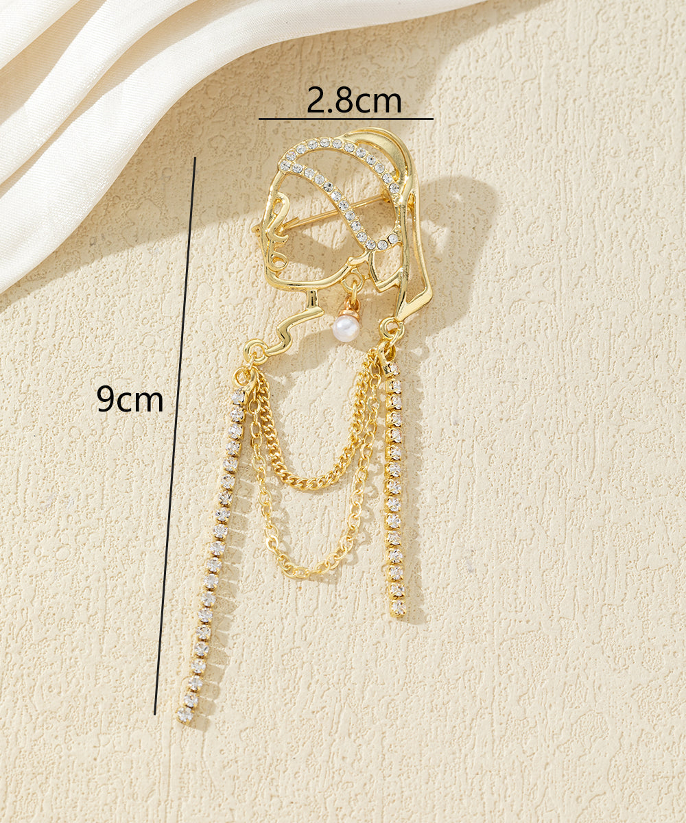 Broche visage féminin avec chaînes strass