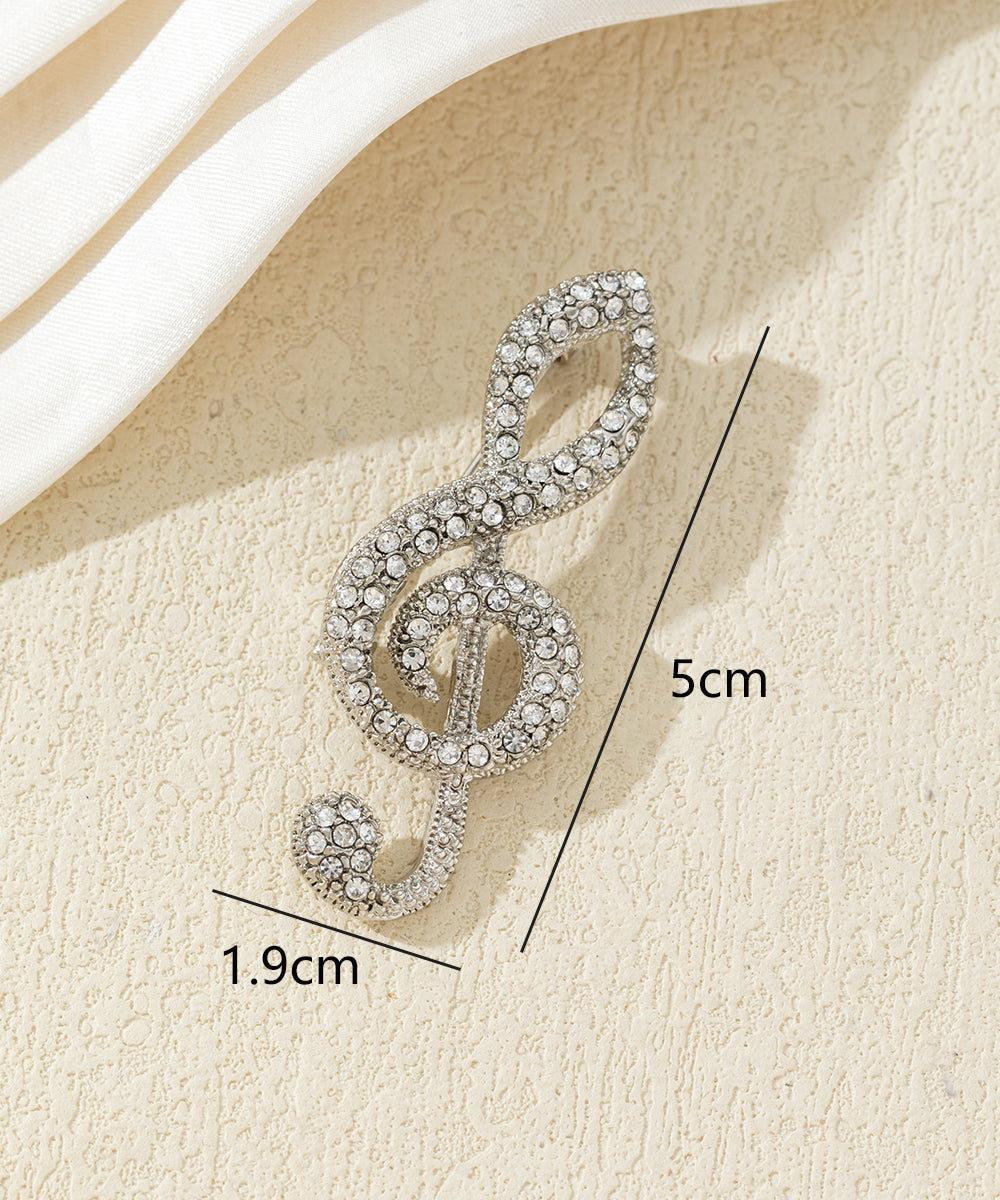 Broche clé de sol strass