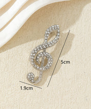 Broche clé de sol strass