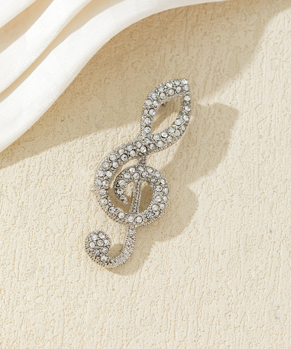Broche clé de sol strass