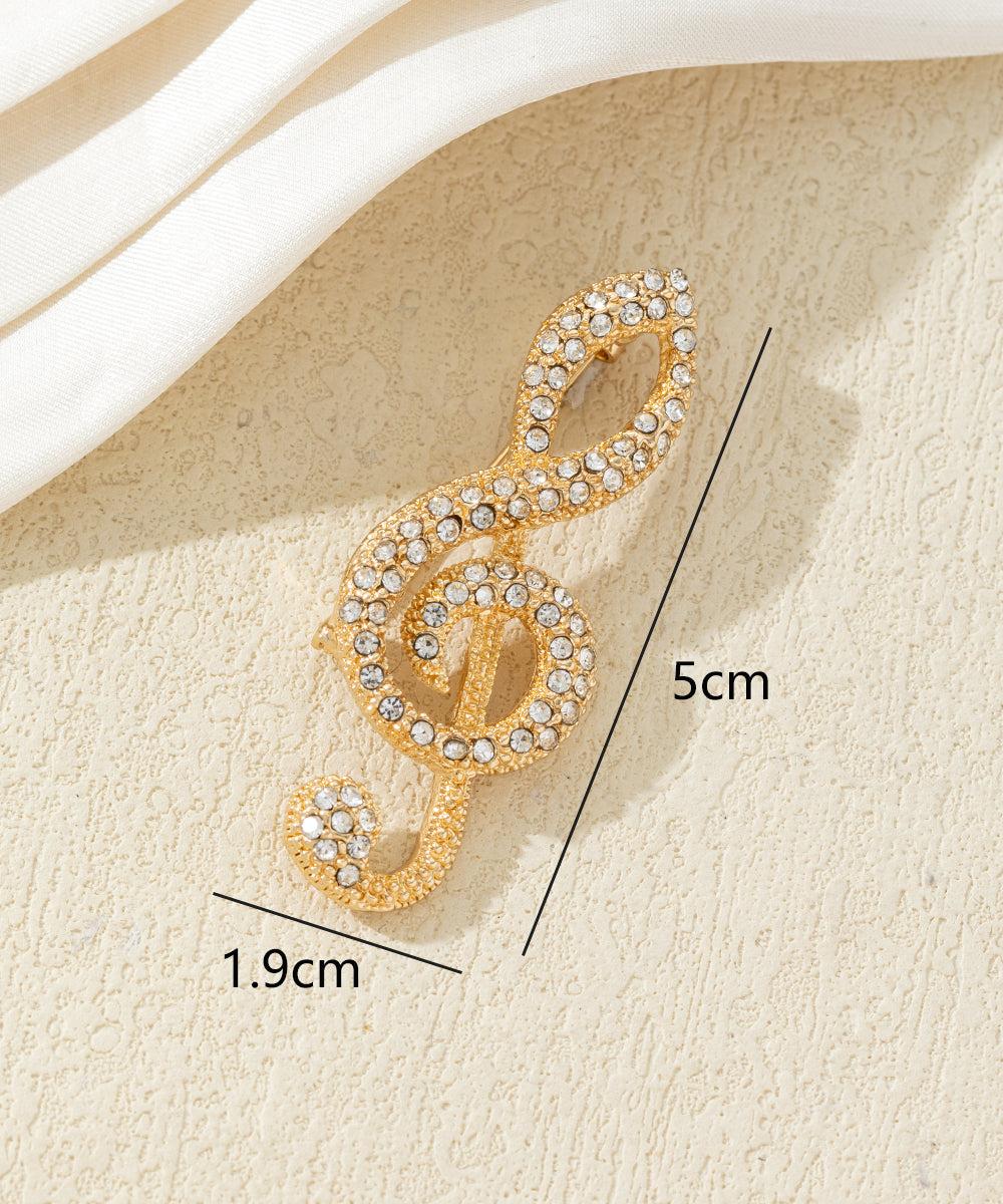 Broche clé de sol strass