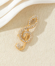 Broche clé de sol strass