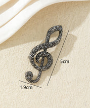 Broche clé de sol strass