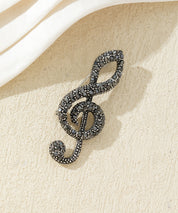 Broche clé de sol strass
